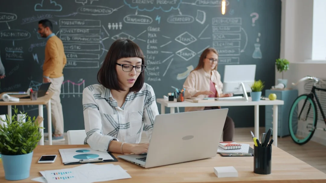 A modern workspace featuring dual computer monitors displaying web design projects, emphasizing technology and productivity.
